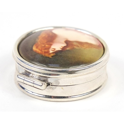 854 - Circular silver patch box, the hinged lid enamelled with a semi nude female, 2.7cm in diameter, 16.2... 