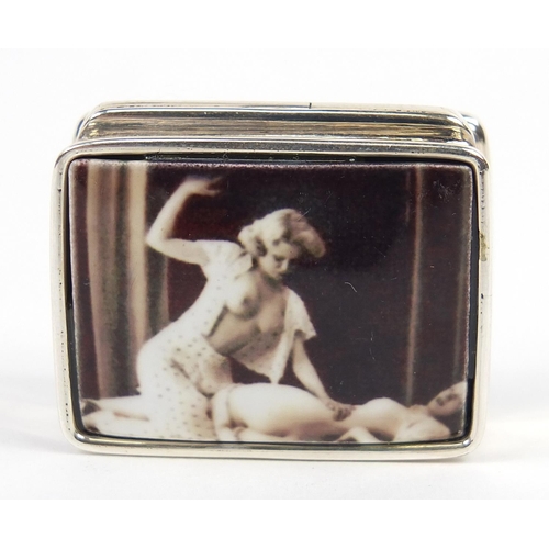 845 - Rectangular silver patch box, the hinged lid enamelled with two erotic females, 3.2cm wide, 20.8g