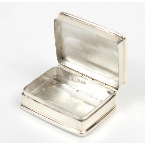 845 - Rectangular silver patch box, the hinged lid enamelled with two erotic females, 3.2cm wide, 20.8g