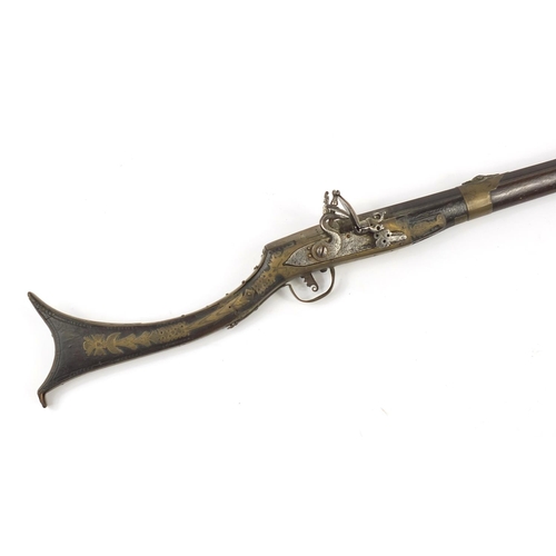 396 - Indian Jezail flintlock musket with engraved brass mounts, dated 1853, 140cm in length