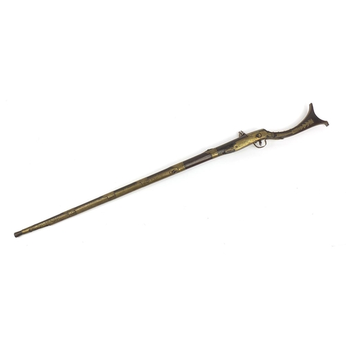 396 - Indian Jezail flintlock musket with engraved brass mounts, dated 1853, 140cm in length