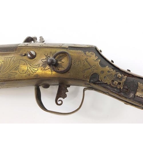 396 - Indian Jezail flintlock musket with engraved brass mounts, dated 1853, 140cm in length