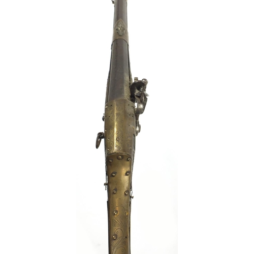 396 - Indian Jezail flintlock musket with engraved brass mounts, dated 1853, 140cm in length