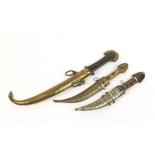 403 - Three Moroccan Koummya daggers with scabbards including one with segmented horn handle, another with... 