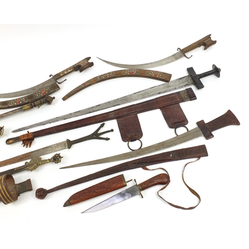 408 - Indian and Tibetan weapons including two swords with leather scabbards and Kartika, the largest 88cm... 