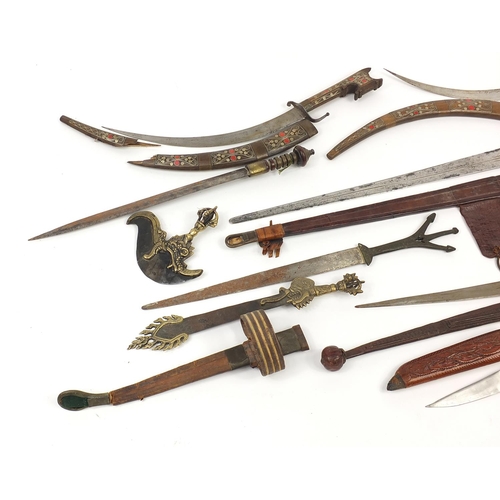 408 - Indian and Tibetan weapons including two swords with leather scabbards and Kartika, the largest 88cm... 