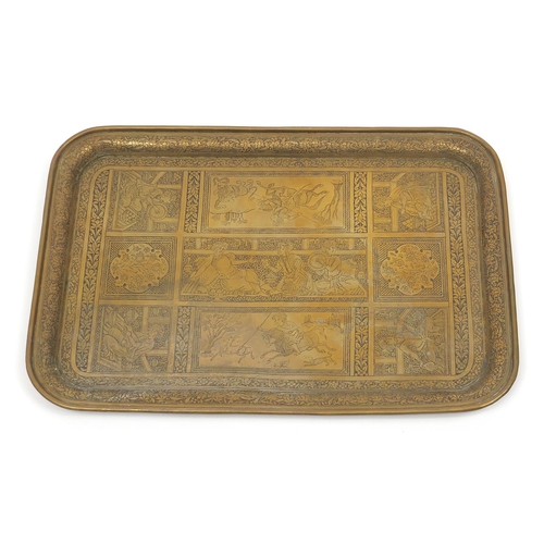 63 - Good Persian brass tray finely engraved with panels of huntsmen, wild animals and flowers, 50cm x 34... 