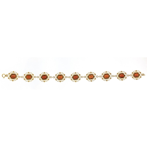 211 - 9ct gold garnet bracelet, 18cm in length, 8.2g