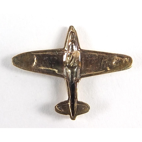 1208 - 9ct gold Spitfire lapel pin with gilt metal fitting, the pin 2cm wide, 0.9g