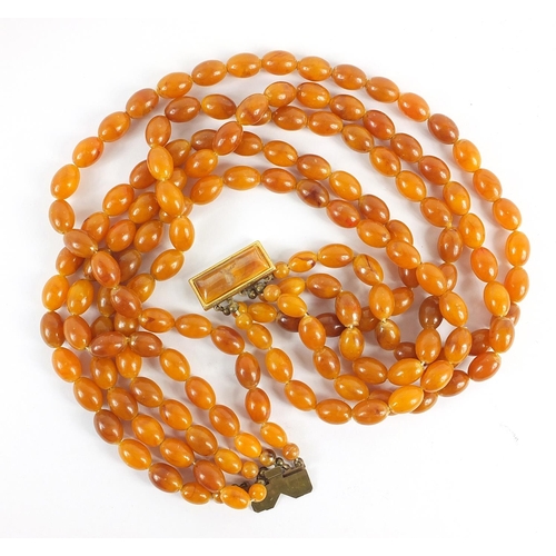 121 - Butterscotch amber coloured graduated five row necklace, the shortest row 40cm in length, total 124.... 