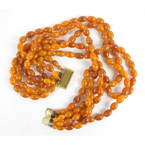 121 - Butterscotch amber coloured graduated five row necklace, the shortest row 40cm in length, total 124.... 