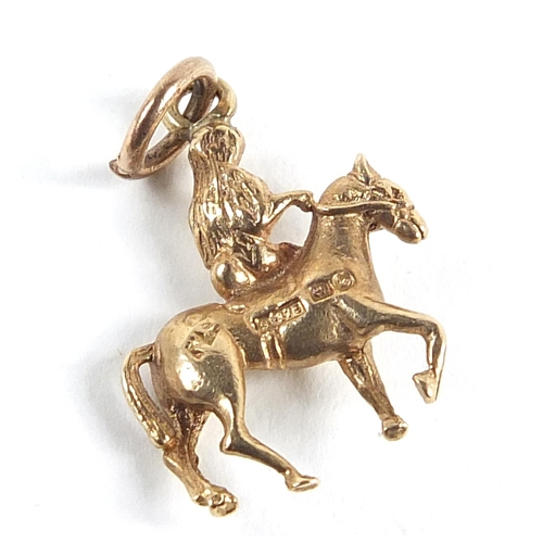 263 - 9ct gold nude female on horseback, possibly Lady Godiva, 1.6cm high, 1.6g