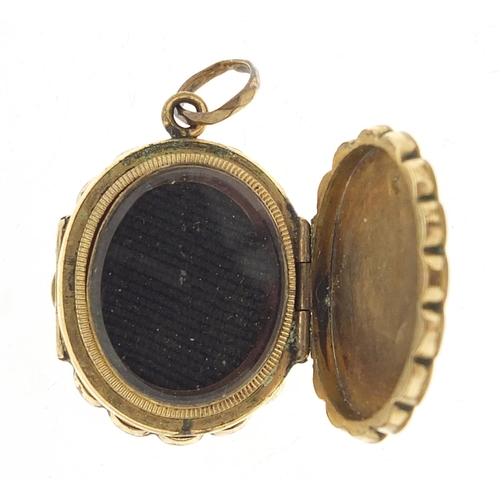 935 - Victorian pinchbeck locket with bevelled glass inserts and engine turned decoration, 2.5cm high, 7.2... 