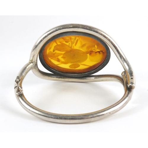 122 - Large unmarked silver and natural amber hinged bangle, 66.8g