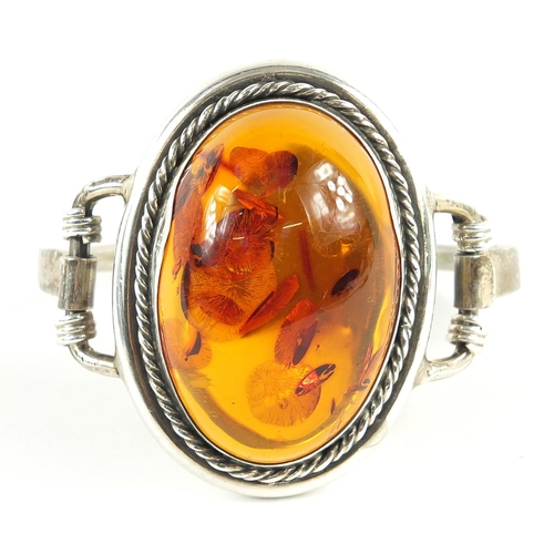 550 - Large silver and natural amber bangle, 61.3g