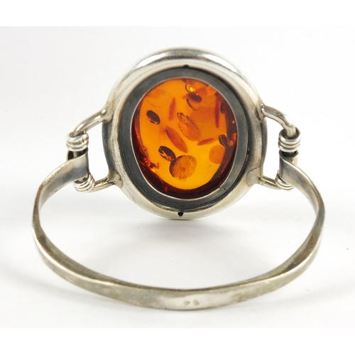 550 - Large silver and natural amber bangle, 61.3g