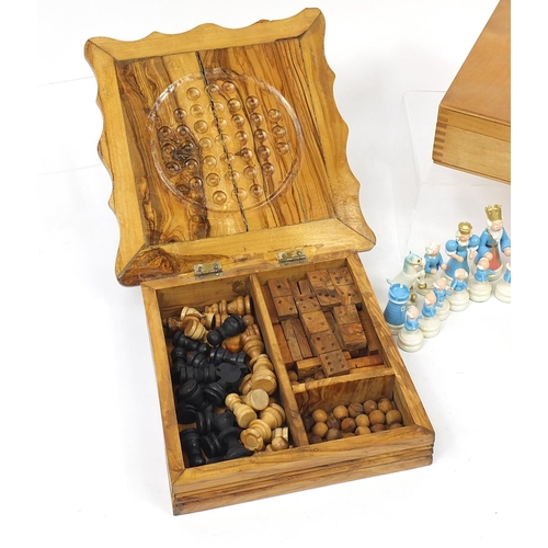 1243 - Two wooden games compendiums and a hand painted figural set, the largest 25cm wide