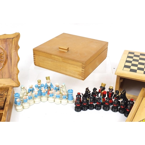 1243 - Two wooden games compendiums and a hand painted figural set, the largest 25cm wide