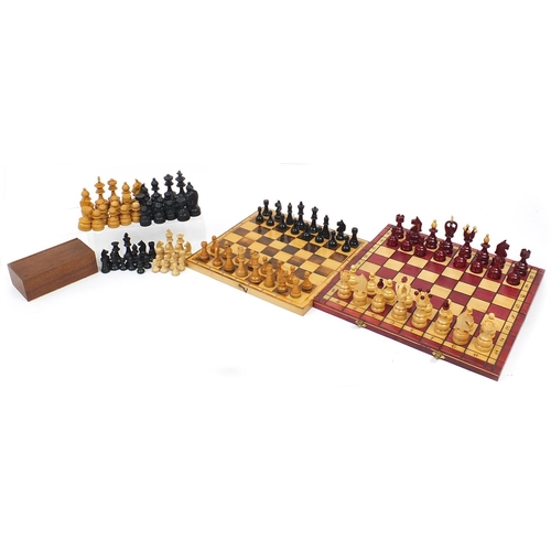 1244 - Four wooden chess sets including two folding boards, the largest 45.5cm wide