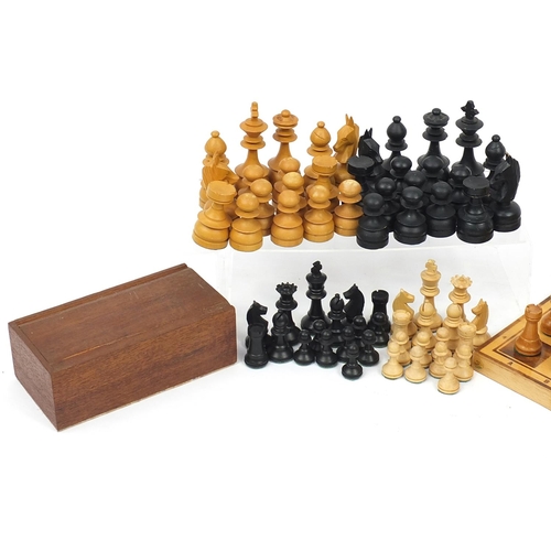 1244 - Four wooden chess sets including two folding boards, the largest 45.5cm wide