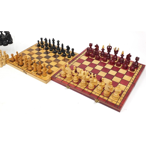 1244 - Four wooden chess sets including two folding boards, the largest 45.5cm wide