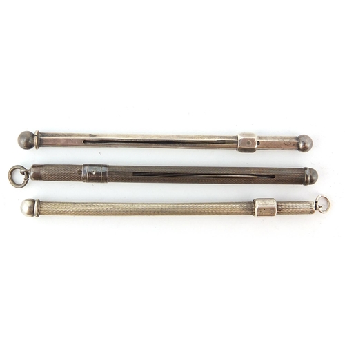 766 - Three silver propelling cocktail swizzle sticks, 8cm in length, 15.2g