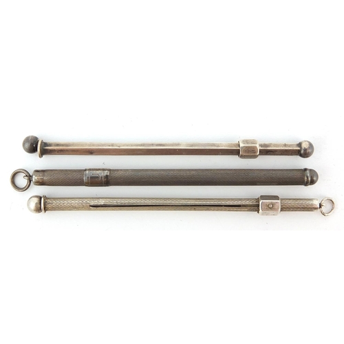 766 - Three silver propelling cocktail swizzle sticks, 8cm in length, 15.2g