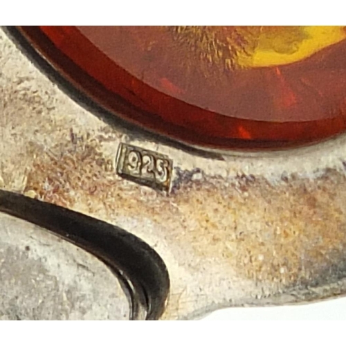 461 - Large silver and natural amber pendant on a silver necklace, the pendant 6cm high, total 45.2g