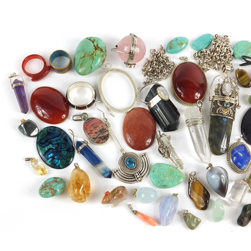 876 - Selection of spiritual healing crystal pendants and stones, some with silver mounts