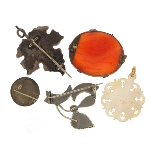 604 - Vintage and later jewellery comprising four silver hardstone and carved mother of pearl pendant, the... 