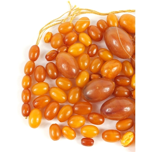 738 - Butterscotch amber coloured beads, the largest 3cm in length, total 80.0g