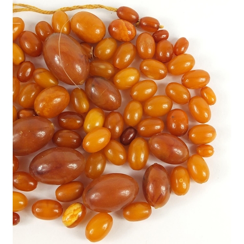 738 - Butterscotch amber coloured beads, the largest 3cm in length, total 80.0g