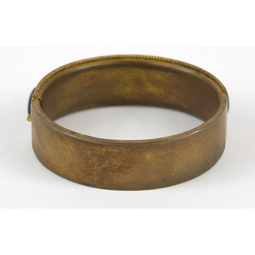 607 - Victorian gilt metal Scottish agate hinged bangle, 38.0g