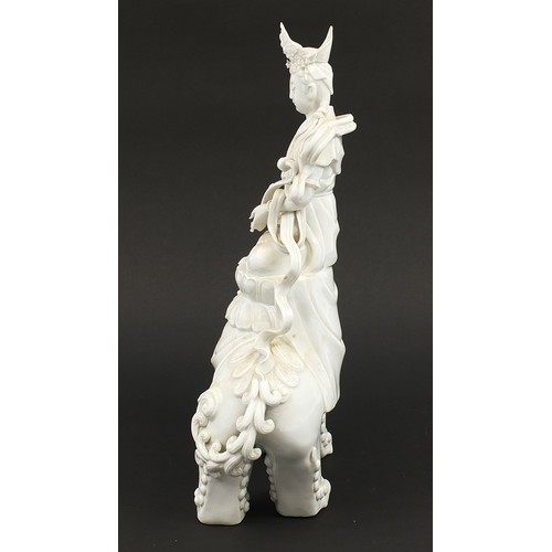 970A - Large Chinese blanc de chine porcelain figure of Guan Yin on a shi shi, 41cm