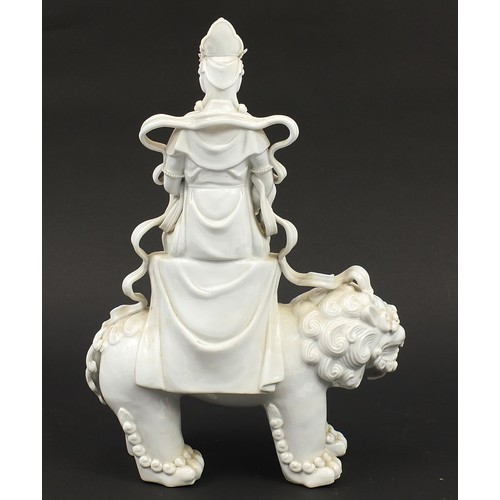 970A - Large Chinese blanc de chine porcelain figure of Guan Yin on a shi shi, 41cm