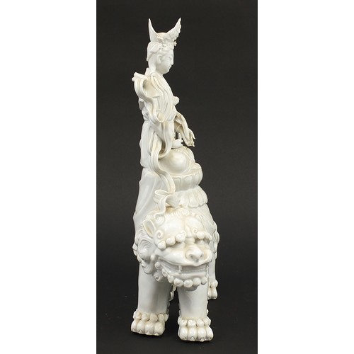 970A - Large Chinese blanc de chine porcelain figure of Guan Yin on a shi shi, 41cm