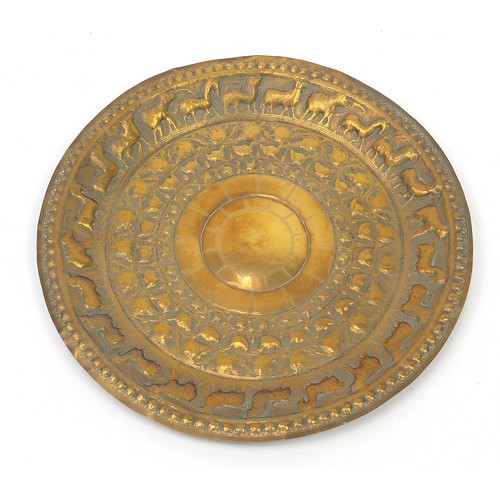 472 - Four good Indian brass trays comprising an octagonal example profusely and finely embossed with flow... 