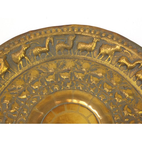 472 - Four good Indian brass trays comprising an octagonal example profusely and finely embossed with flow... 