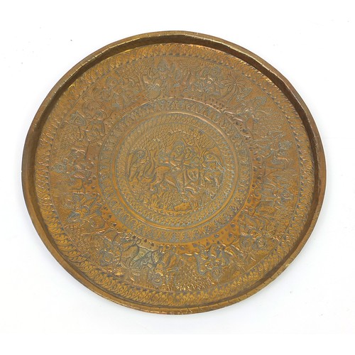 472 - Four good Indian brass trays comprising an octagonal example profusely and finely embossed with flow... 