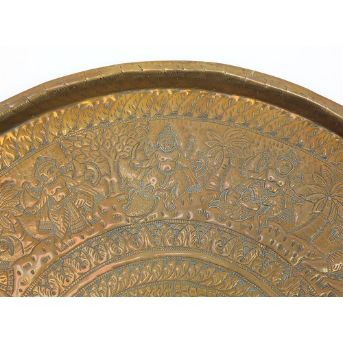 472 - Four good Indian brass trays comprising an octagonal example profusely and finely embossed with flow... 