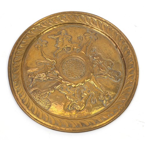 470 - Two good Indian brass trays including one finely embossed with huntsmen and wild animals, the larges... 