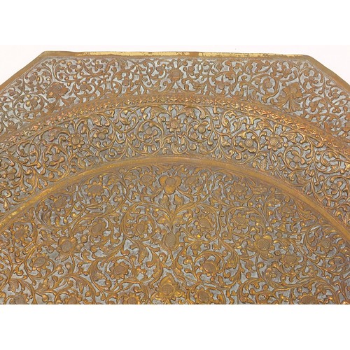 472 - Four good Indian brass trays comprising an octagonal example profusely and finely embossed with flow... 