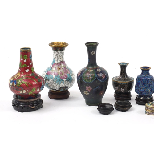 972 - Chinese and Japanese cloisonné vases and boxes enamelled with flowers, raised on hardwood stands, th... 