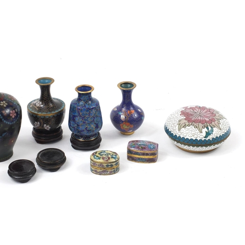 972 - Chinese and Japanese cloisonné vases and boxes enamelled with flowers, raised on hardwood stands, th... 