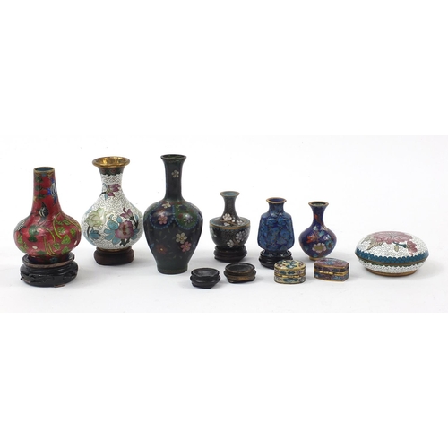 972 - Chinese and Japanese cloisonné vases and boxes enamelled with flowers, raised on hardwood stands, th... 