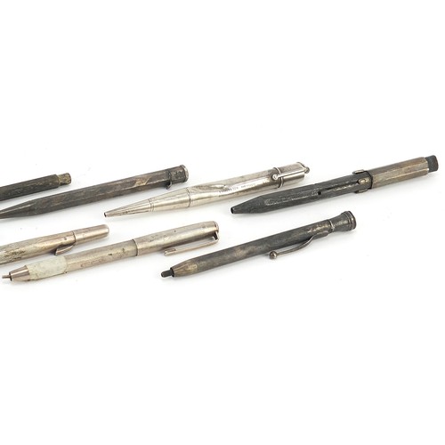 24 - Nine silver propelling pencils and pens, the largest 13cm in length