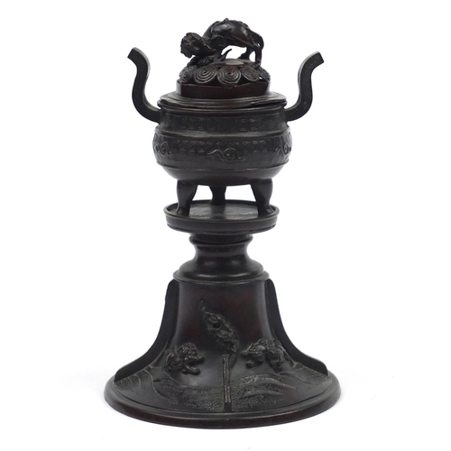 573 - Japanese patinated bronze lidded incense burner on stand, cast with Foo dogs and birds, 22cm high