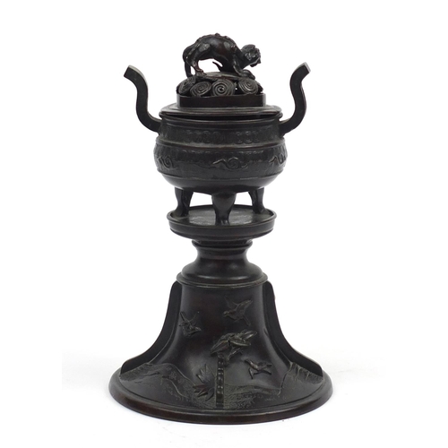 573 - Japanese patinated bronze lidded incense burner on stand, cast with Foo dogs and birds, 22cm high