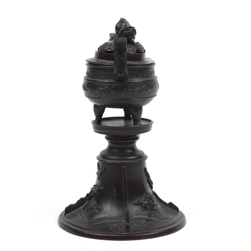 573 - Japanese patinated bronze lidded incense burner on stand, cast with Foo dogs and birds, 22cm high