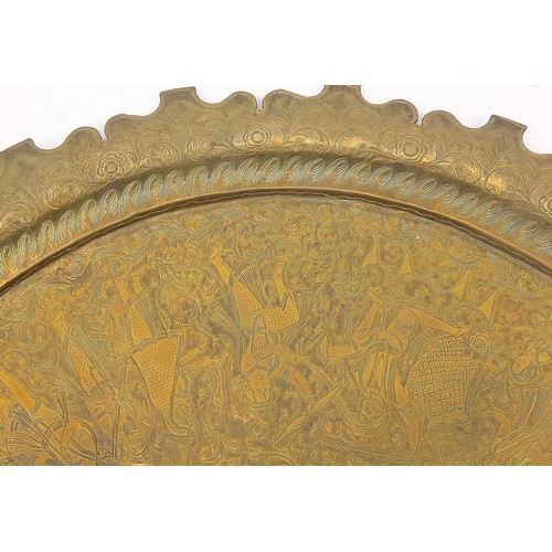 469 - Two good Indian brass trays comprising one finely embossed with two figures and wild animals amongst... 